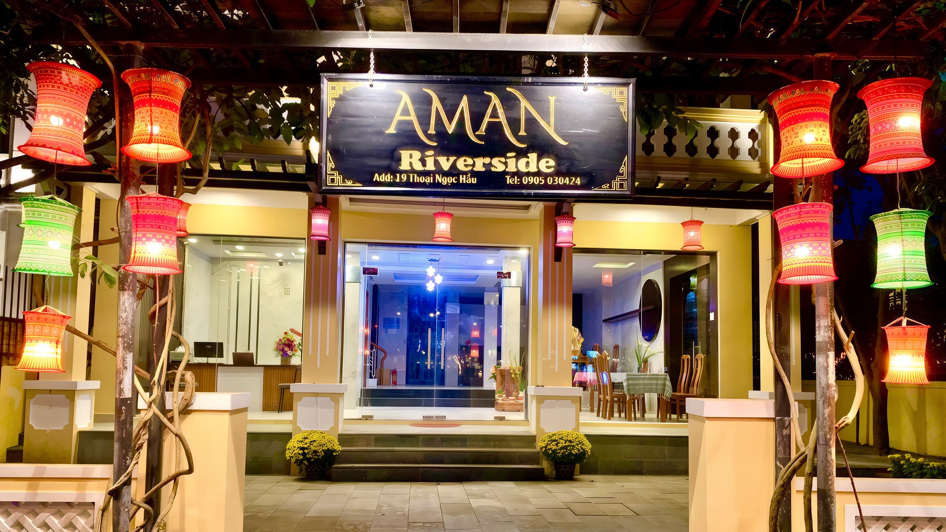 View of Aman Riverside hotel from across the river at dusk